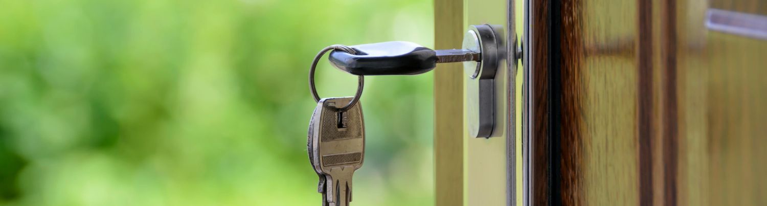 A key dangles from the lock on a door of a house that is disputed marital property